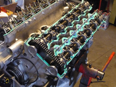 The cylinder heads are massive, housing 2 overhead cams each. Intake is directly from each carb throat (15089).